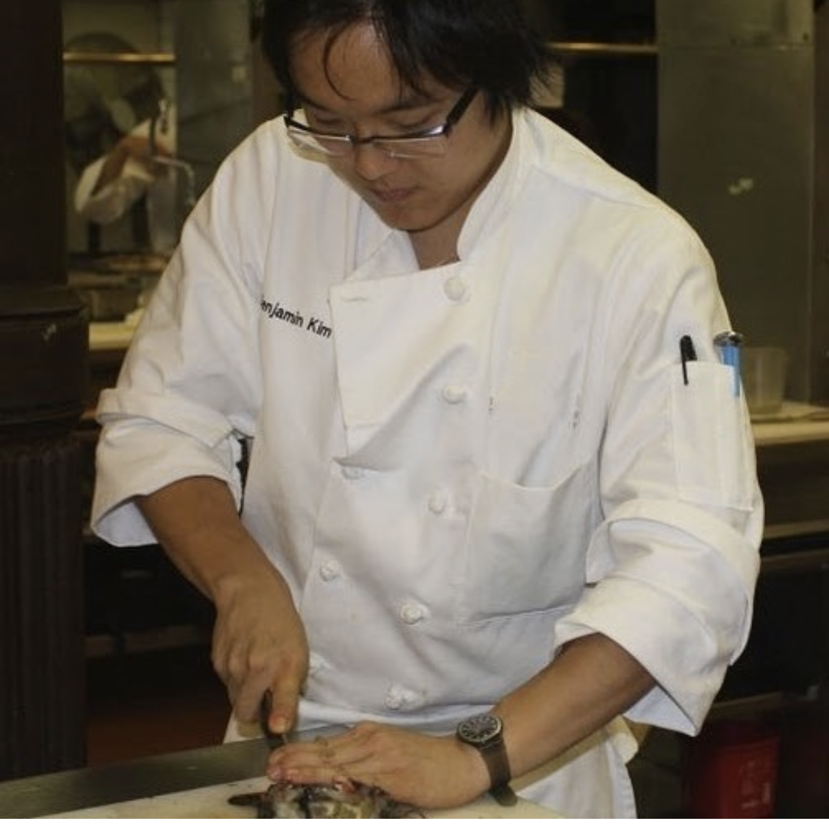 Benji preparing food in a chef’s jacket